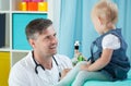 Smiling pediatrician and his little patient