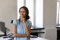 Smiling pensive African businesswoman looking into distance Royalty Free Stock Photo