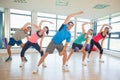 Smiling people doing power fitness exercise at yoga class Royalty Free Stock Photo