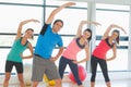 Smiling people doing power fitness exercise at yoga class Royalty Free Stock Photo