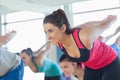 Smiling people doing power fitness exercise at yoga class Royalty Free Stock Photo