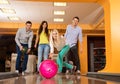 Smiling people playing bowling