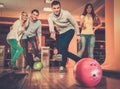 Smiling people playing bowling