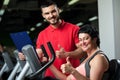 Smiling personal coach with female client in gym. Royalty Free Stock Photo