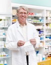 Smiling pharmacist at drugstore. Portrait of pharmacist smiling with prescription at drugstore. Royalty Free Stock Photo