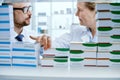 smiling pharmacist standing near a shelf of medicines. Royalty Free Stock Photo