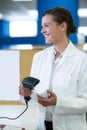 Smiling pharmacist using barcode scanner on medicine bottle Royalty Free Stock Photo