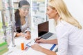 smiling pharmacist writing prescription and looking at customer Royalty Free Stock Photo