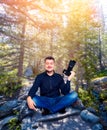Smiling photographer with camera in yoga pose