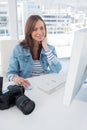 Smiling photographer editing at desk Royalty Free Stock Photo