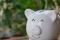 Smiling piggy bank with bokeh background. Savings and investment concept. Copy space.