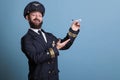 Smiling pilot with uniform playing with airplane model Royalty Free Stock Photo