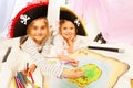 Smiling pirates drawing the map of Treasure Island Royalty Free Stock Photo