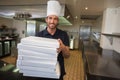 Smiling pizza chef holding stack of pizza boxes Royalty Free Stock Photo