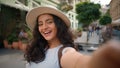 Smiling playful Indian Arabian woman female student girl tourist traveler blogger holding mobile phone looking camera Royalty Free Stock Photo