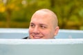 Smiling playful young man crouching down in a tank Royalty Free Stock Photo