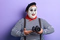 Smiling pleasant mime with white face taking picture