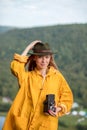 Smiling pleasant traveller taking photos outdoors