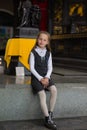 Smiling pleasantly cheerful positive girl regarding ancient statues in museum Royalty Free Stock Photo