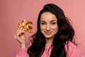 Smiling pleased cute young dark-haired woman snacking on her favorite Italian food during the studio photo shoot Royalty Free Stock Photo