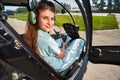 Joyous airwoman sitting in helicopter cabin before flight Royalty Free Stock Photo
