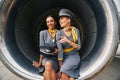 Young attractive flight attendants seated in the aeroengine