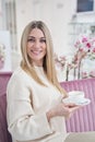 Contented beauty salon customer with beverage looking ahead