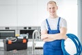 Smiling plumber with blue pipes Royalty Free Stock Photo