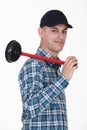 Smiling plumber holding plunger Royalty Free Stock Photo