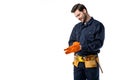 smiling plumber in uniform wearing protective gloves