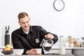 smiling police officer pouring filtered coffee from glass pot