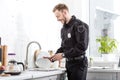 Smiling police officer washing plate Royalty Free Stock Photo