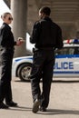 smiling police officers having coffee break and chatting in front Royalty Free Stock Photo