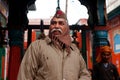 Smiling policeman guarding the hindu temple