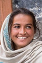 Smiling poor girl begs for money from a passerby on the street in Leh, Ladakh. India