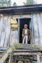 A smiling poor man stands at the door of his hut on March 30, 2018 in Nepal.