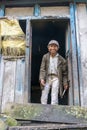 A smiling poor man stands at the door of his hut on March 30, 2018 in Nepal.