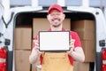 Smiling portrait of courier with tablet app for delivering orders Royalty Free Stock Photo