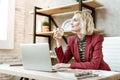 Smiling positive blonde woman carrying water with piece of lemon