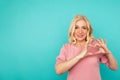 Smiling positive lady showing heart getsure isolated.