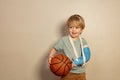 Smiling little blond boy with basketball ball Royalty Free Stock Photo