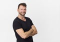 Smiling positive male with attractive look, wearing black shirt, posing against white blank wall Royalty Free Stock Photo