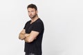 Handsome man wearing black shirt with beautiful smile posing against white background Royalty Free Stock Photo