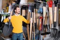 Man choosing new shovel in garden equipment shop Royalty Free Stock Photo