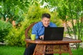 businessman reading good finance news using laptop sitting in his backyard Royalty Free Stock Photo