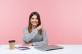 Smiling positive woman advertising agency worker pointing finger away paying attention and showing freespace for your advertising