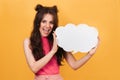A smiling, positive woman of Caucasian appearance holds a blank sheet in the shape of a cloud with a copy of the space Royalty Free Stock Photo