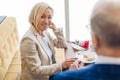 Smiling positive woman having great time with her admirer