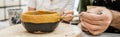 Smiling potters in aprons coloring ceramic