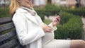 Smiling pregnant girl looking on baby image on her smartphone, love, maternity Royalty Free Stock Photo